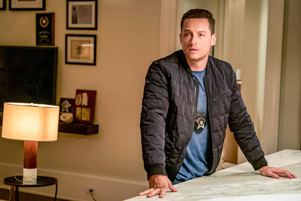 Jesse Lee Soffer as Det. Jay Halstead on 'Chicago P.D' standing at a counter, wearing a badge