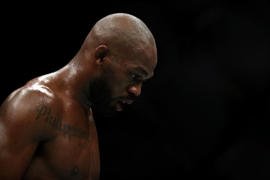 Jon Jones walks to his corner in between rounds against Dominick Reyes in their UFC Light Heavyweight Championship bout during UFC 247 