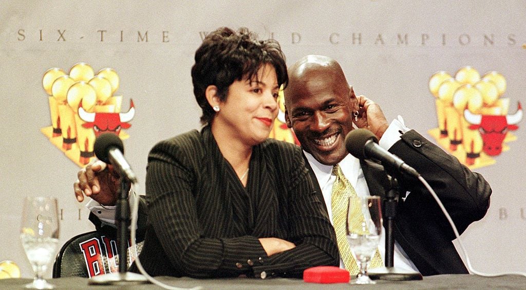 Michael Jordan of the Chicago Bulls (R) laughs as his wife Juanita is questioned by reporters about how her life will change with Michael Jordan's retirement, during a press conference 13 January at the United Center in Chicago, IL. Jordan is retiring from the NBA after 13 seasons. Jordan finished his career leading the Bulls to six NBA titles, five NBA Most Valuable Player awards, ten scoring titles and twelve NBA All-Star game appearance