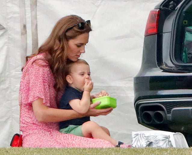Kate Middleton sits with Prince Louis on her lap at a polo match, 2019