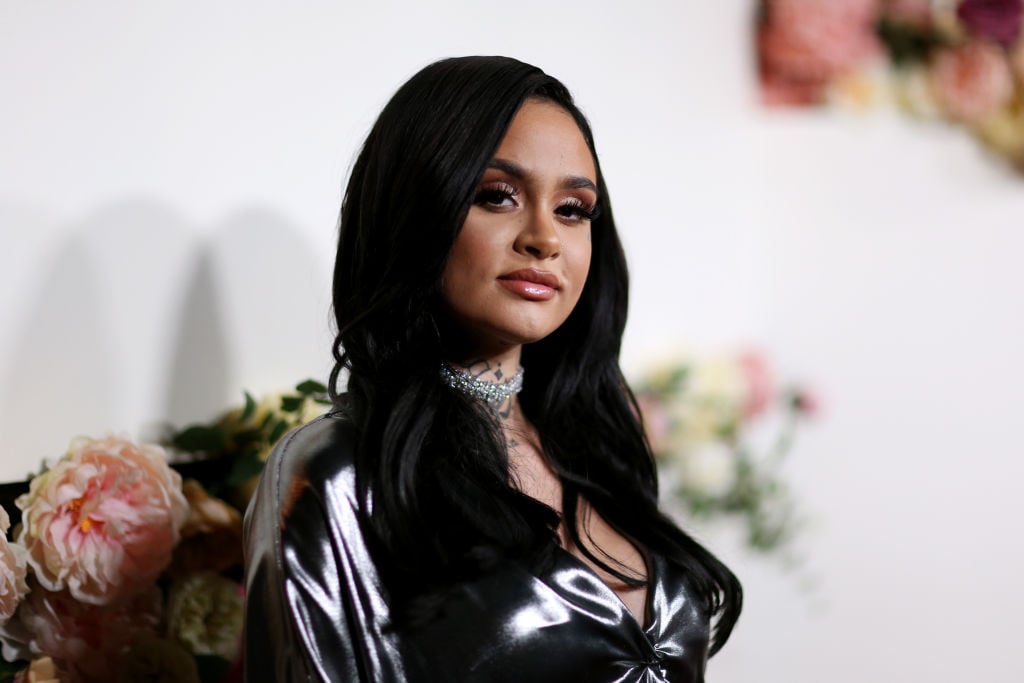 Kehlani, turned slightly to the camera, smiling slightly