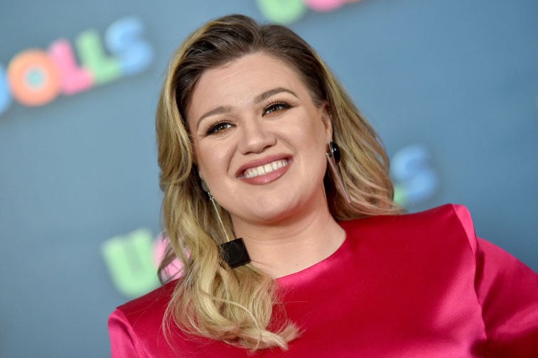 Kelly Clarkson smiling in red outfit