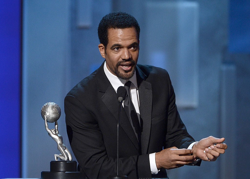 Kristoff St. John at a podium speaking into a microphone