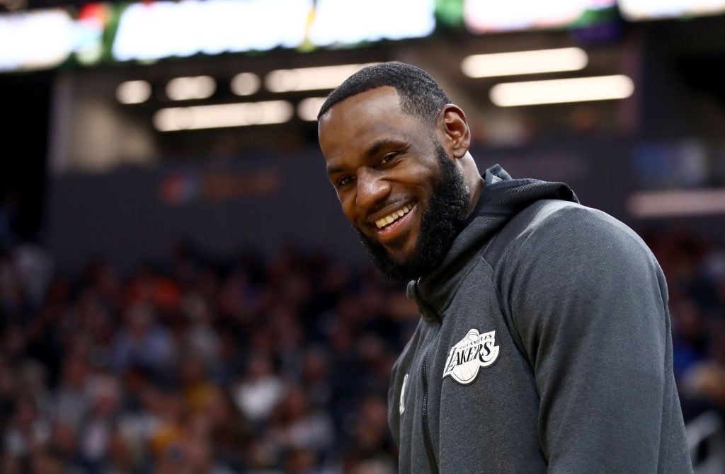 LeBron James smiling in a gray sweatshirt