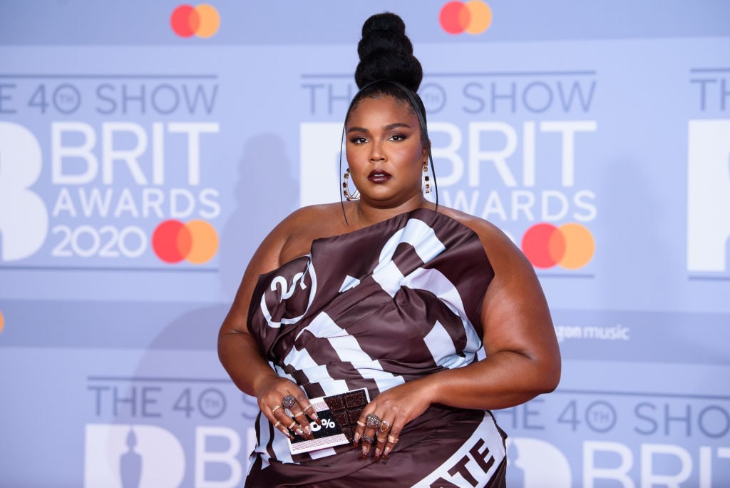 Lizzo in a Hershey's dress in front of a repeating background