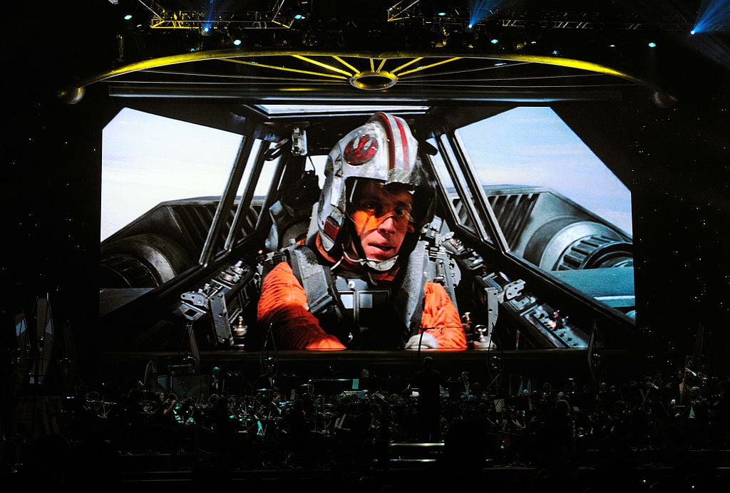 Mark Hamill as Luke Skywalker in 'Star Wars Episode V: The Empire Strikes Back' on screen while musicians perform during Star Wars: In Concert at the Orleans Arena in May 2010 