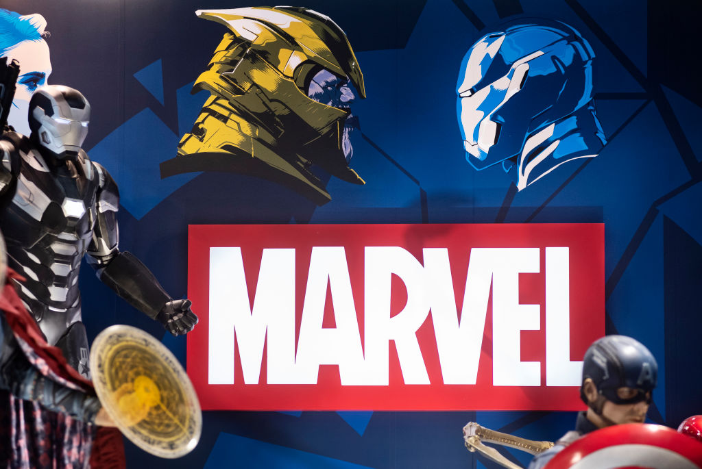 Marvel logo with costume models in front and to the sides