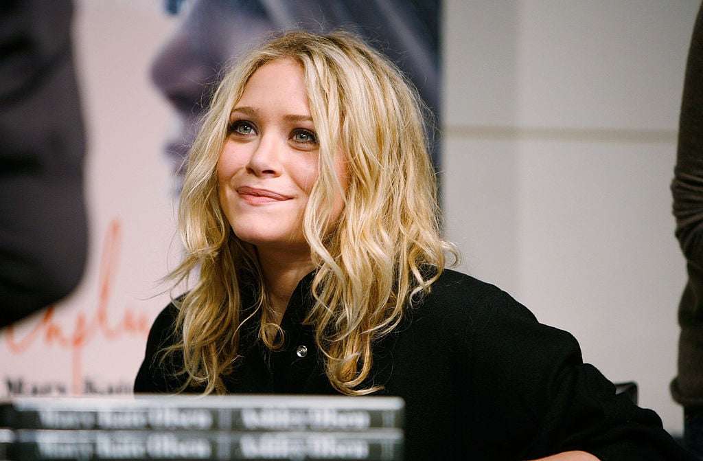 Mary-Kate Olsen smiling, looking away from the camera