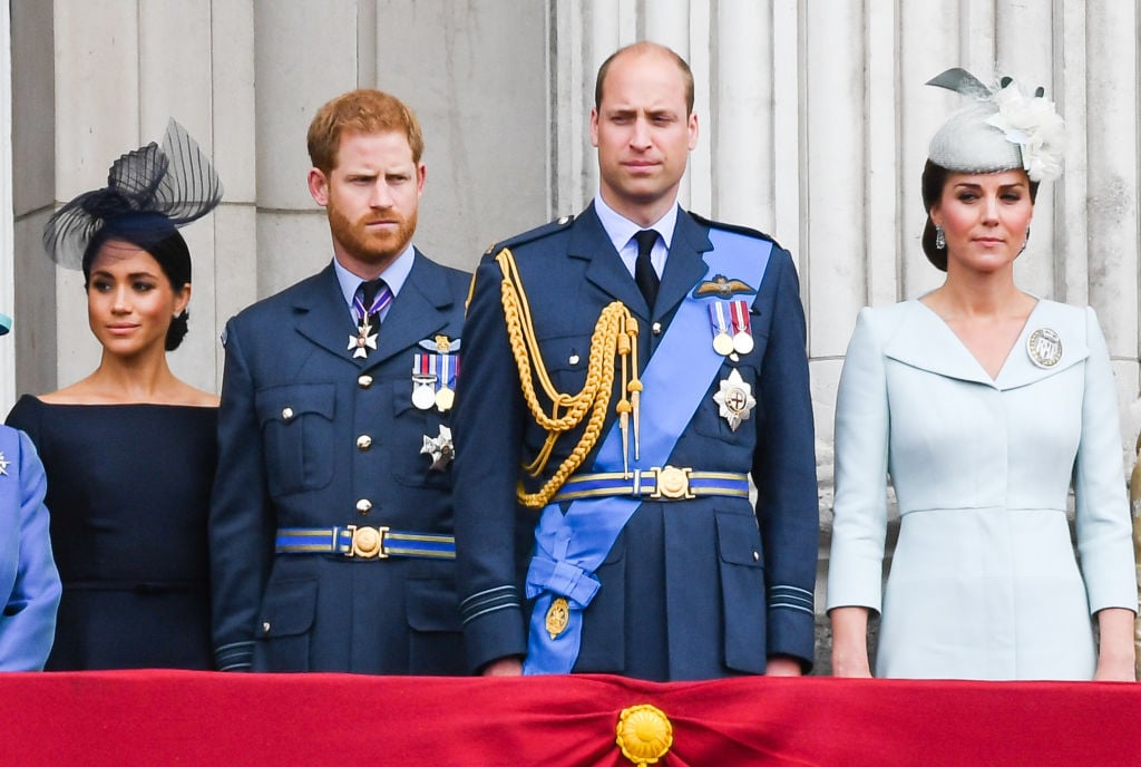 Meghan Markle, Prince Harry, Prince William, and Kate Middleton stand on the balcony of Buckingham Palace to view a flypast to mark the centenary of the Royal Air Force (RAF)