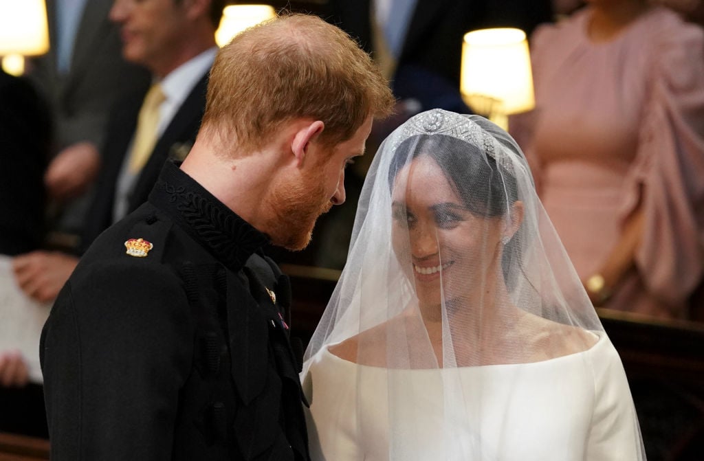 Meghan Markle smiles at Prince Harry as they stand together during their royal wedding