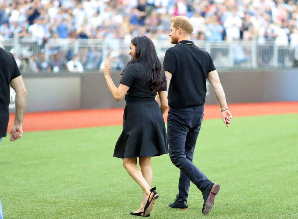 Prince Harry, Duke of Sussex and Meghan, Duchess of Sussex leave the field after accompanying Invictus Games competitors on the field for the ceremonial first pitch before game one of the London Series between the New York Yankees and the Boston Red Sox at London Stadium