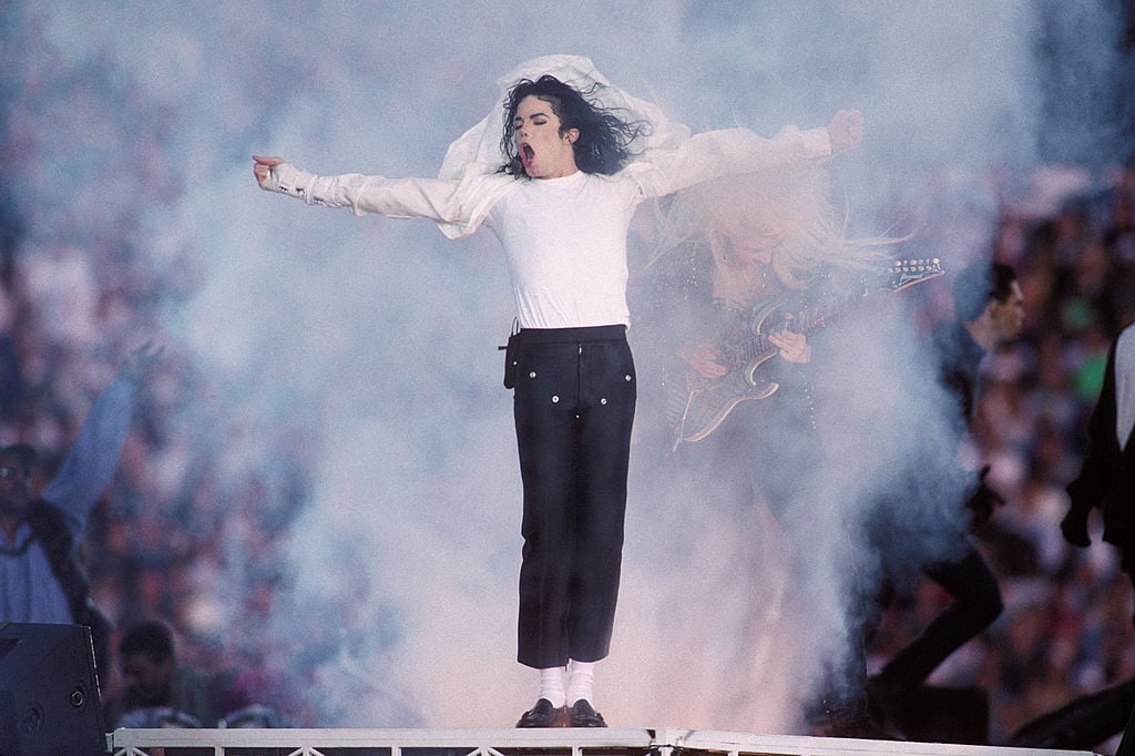 Michael Jackson on stage, head turned, with his mouth open