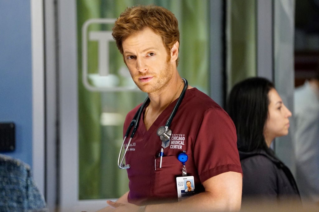 Nick Gehlfuss as Dr. Will Halstead turned toward the camera