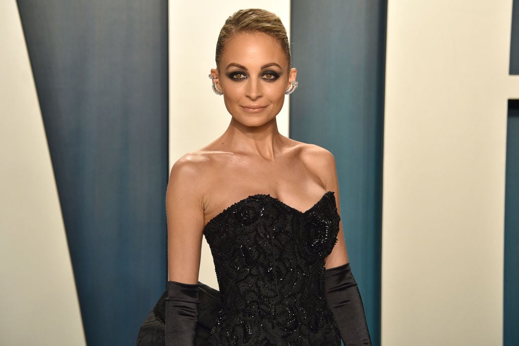 Nicole Richie smiling in a black dress