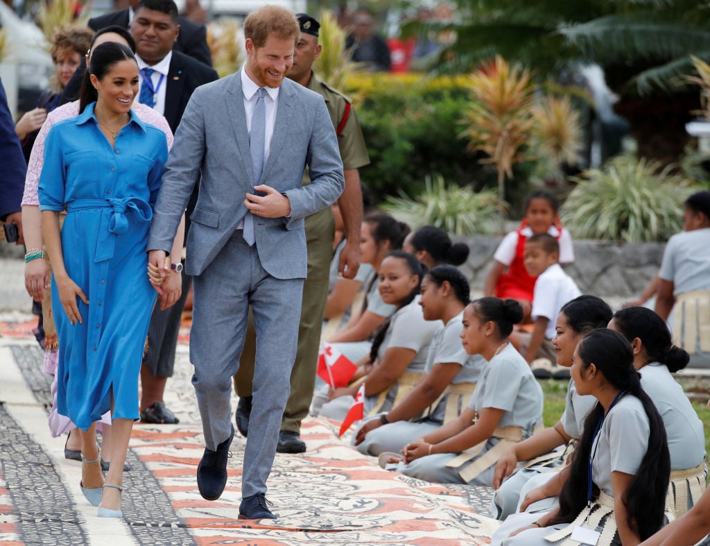 Meghan Markle and Prince Harry leave the airport after arriving in Tonga