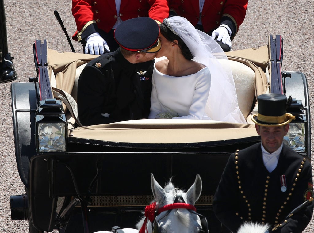 Prince Harry and Meghan Markle kiss at the end of their royal wedding carriage procession