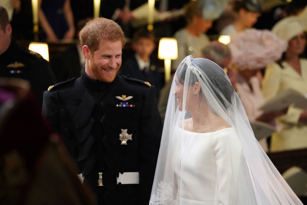 Prince Harry and Meghan Markle smile at each other during their 2018 royal wedding