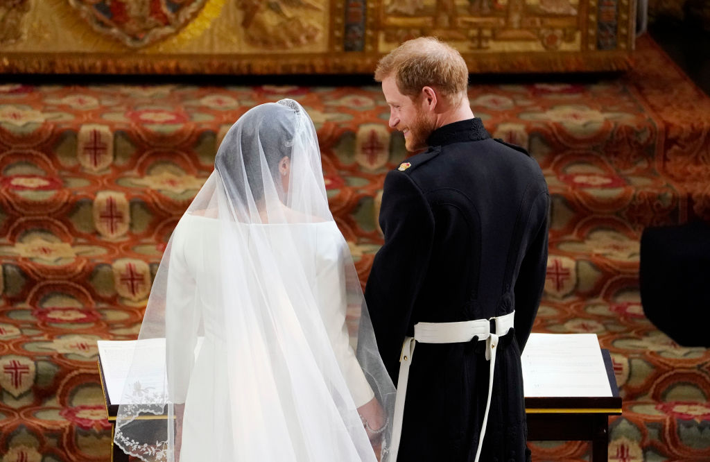 Prince Harry and Meghan Markle stand next to each other at the altar during their royal wedding