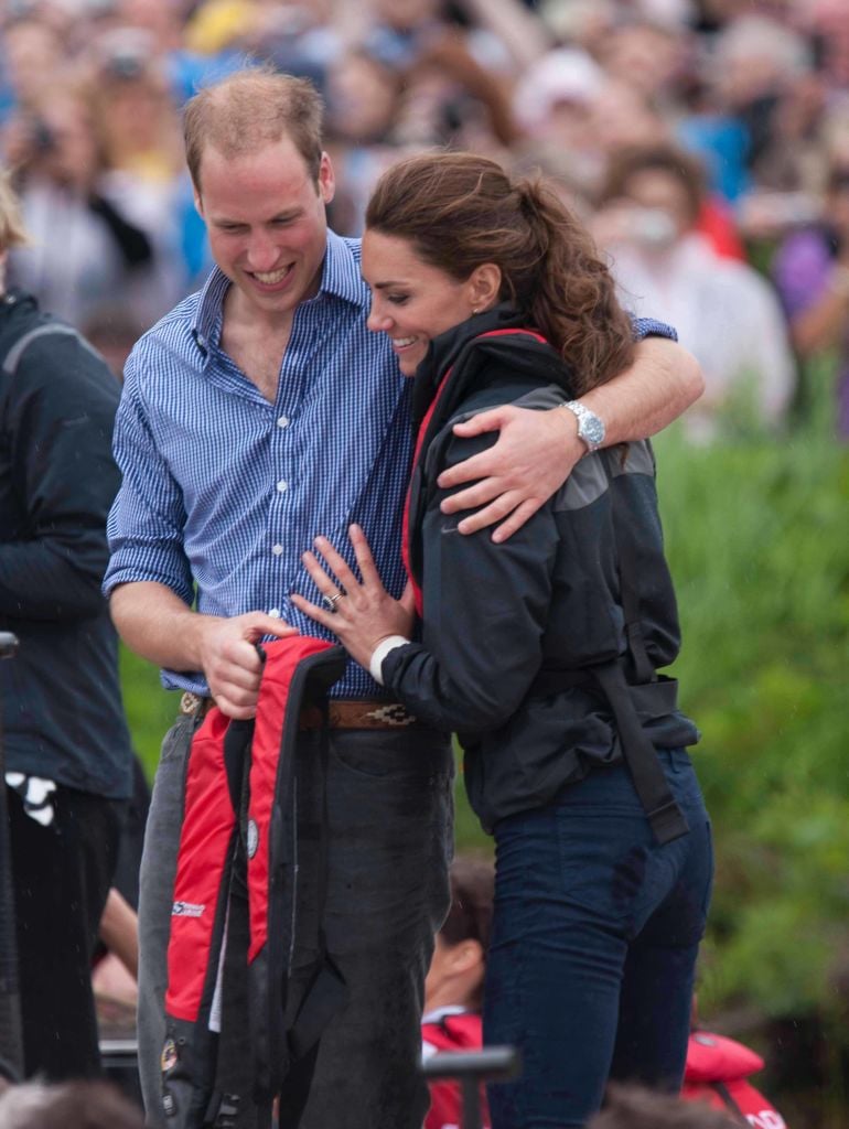 Kate Middleton and Prince William put their arms around each other