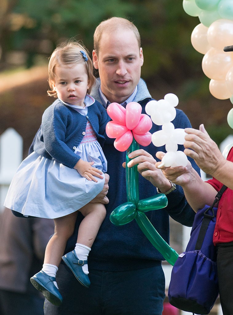 Prince William and Princess Charlotte play with balloons