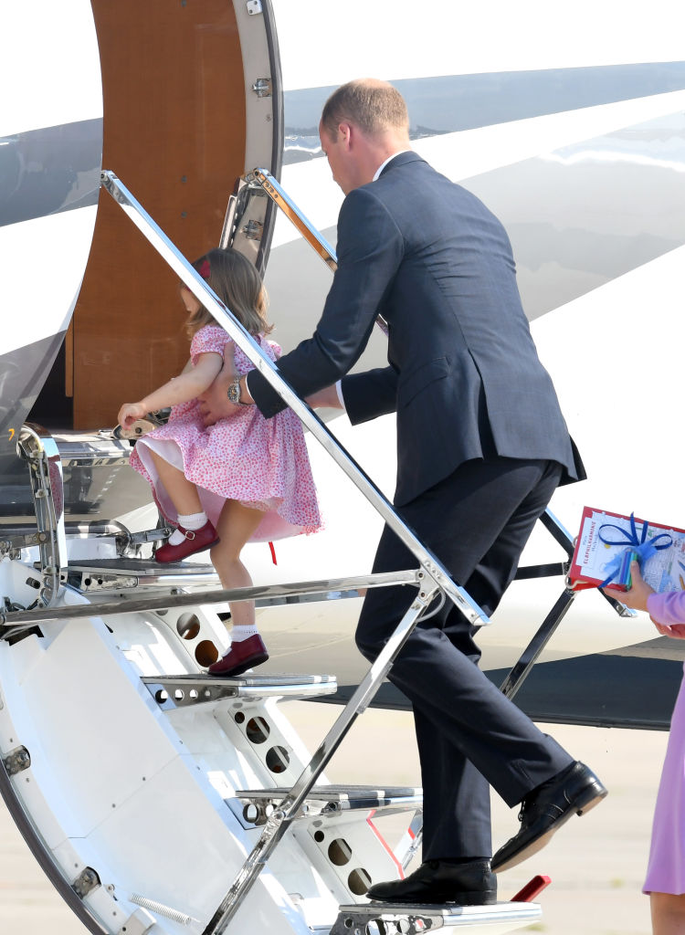 Prince William helps Princess Charlotte board a plane in Germany