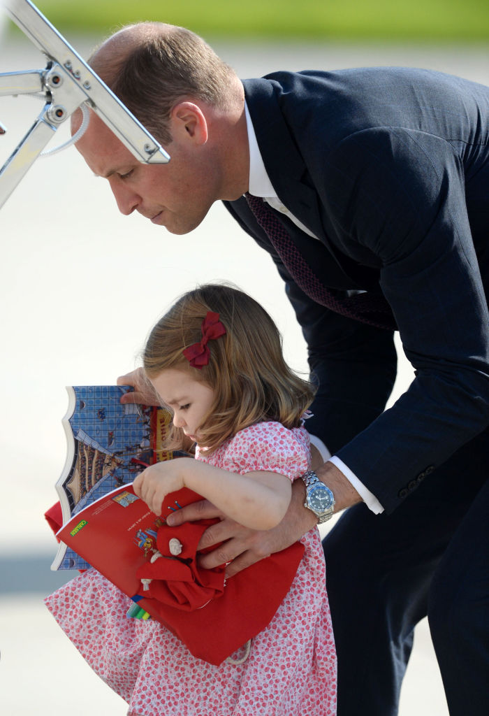 Prince William helps Princess Charlotte board a plane
