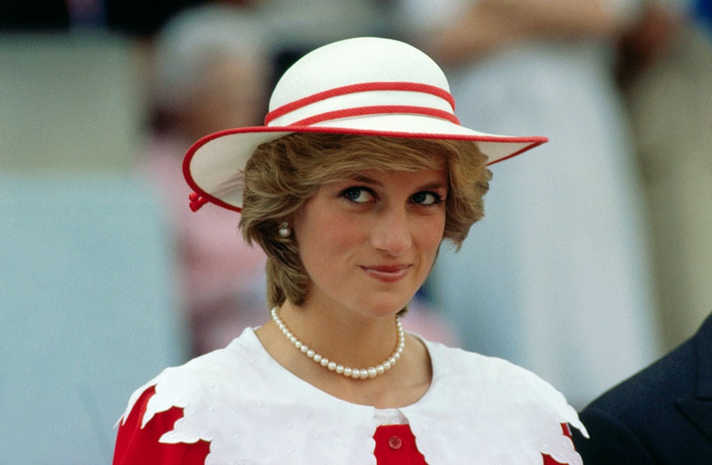 Diana, Princess of Wales, wears an outfit in the colors of Canada during a state visit to Edmonton, Alberta, with her husband