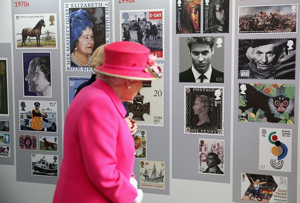 Queen Elizabeth II looking at stamps