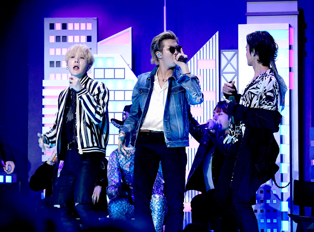 SUGA, RM, and V of BTS perform onstage during the 62nd Annual GRAMMY Awards