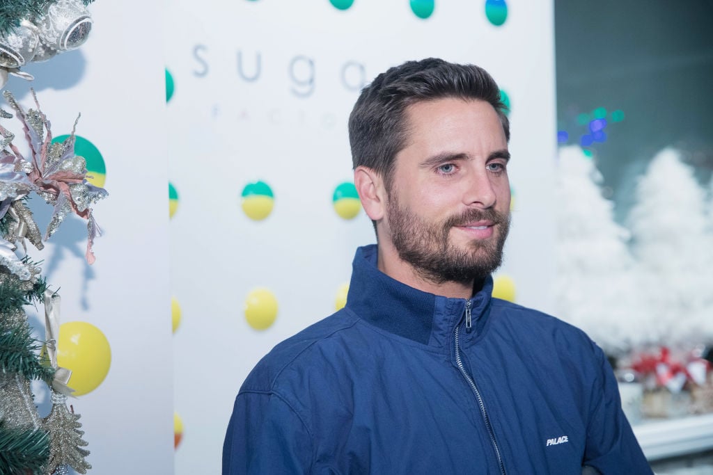 Scott Disick slightly smiling wearing a blue jacket