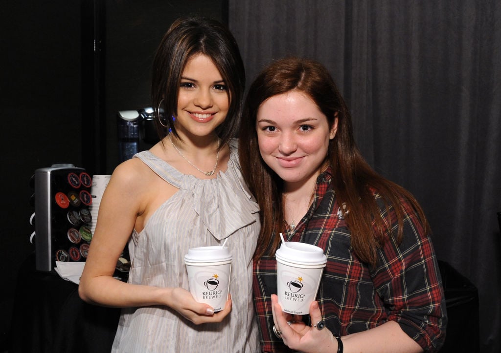 Selena Gomez and Jennifer Stone smiling holding coffee cups