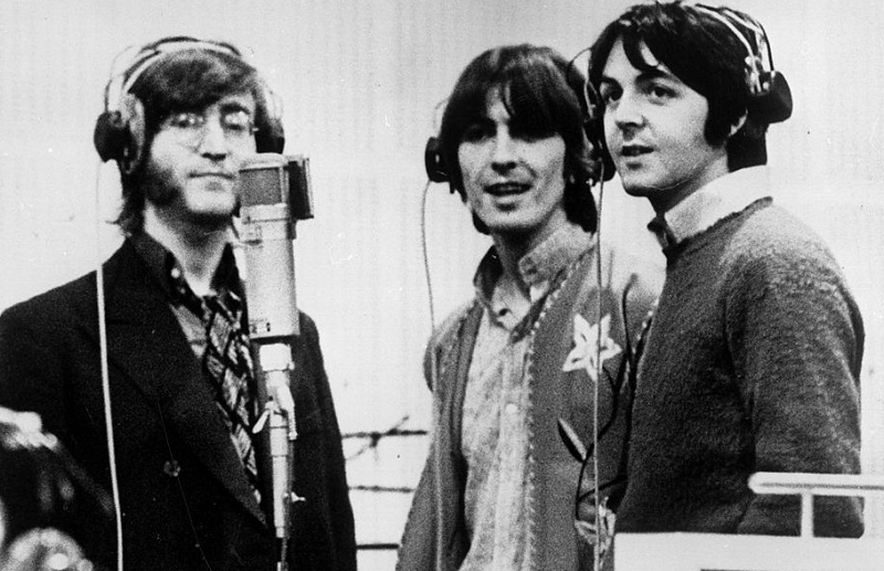 Lennon, George Harrison, McCartney at a microphone