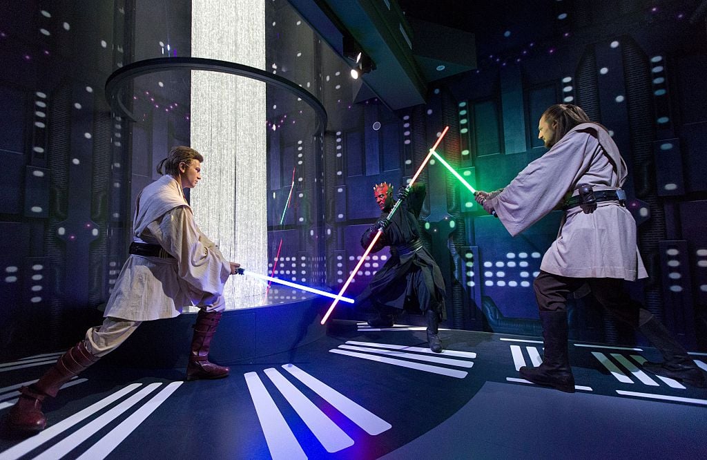 Wax figures of Obi-Wan Kenobi, Darth Maul, and Qui Gon Jinn at the Star Wars At Madame Tussauds attraction in London set up in the 'Duel of the Fates' scene from 'The Phantom Menace'
