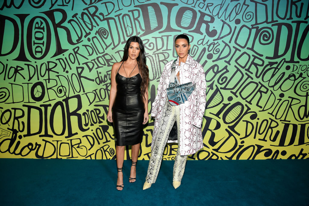 Kourtney Kardashian and Kim Kardashian West attend the Dior Men's Fall 2020 Runway Show