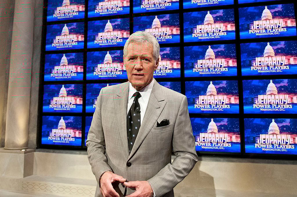 Alex Trebek stands in front of monitors at a rehearsal for taping of 'Jeopardy!' Power Players Week
