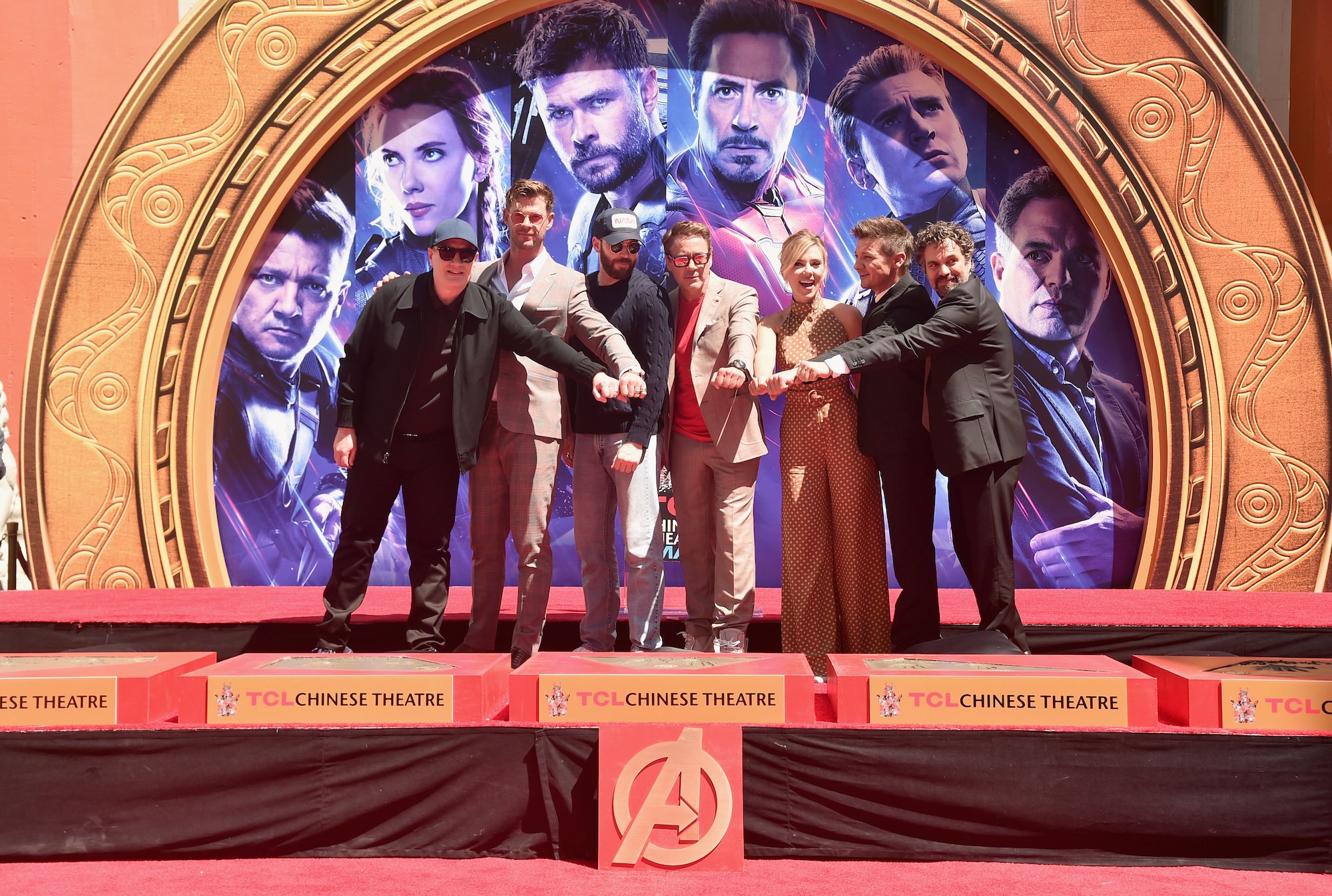 Avengers: Endgame cast in front of a movie display