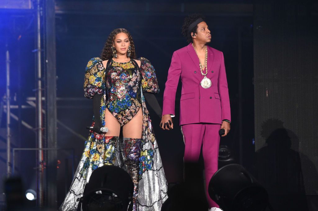 Beyoncé and Jay-Z smiling on stage, holding hands