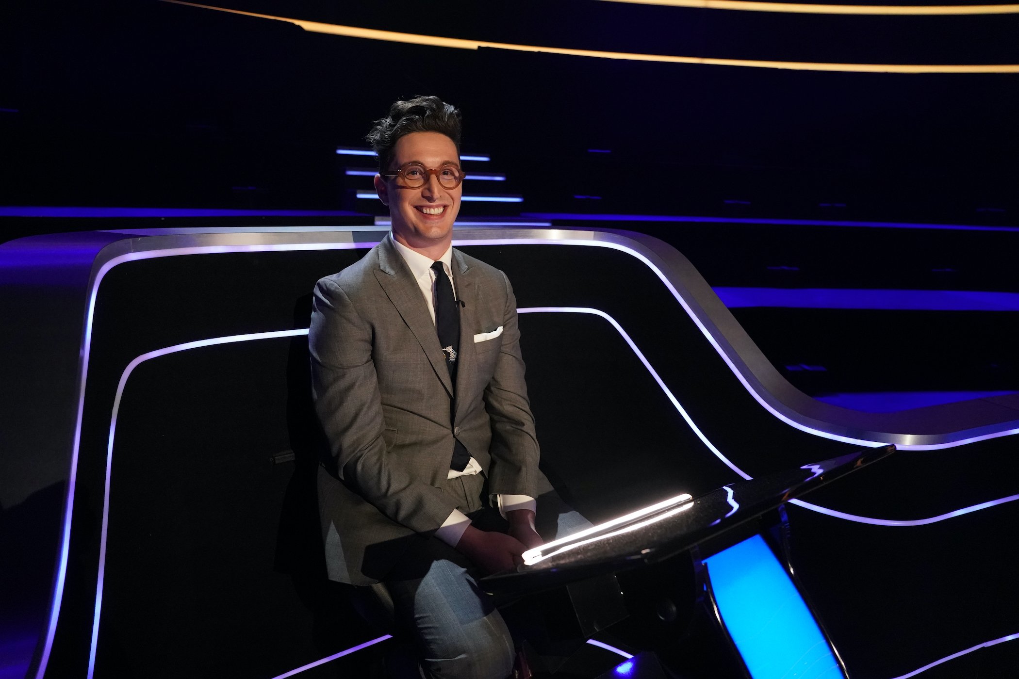 Buzzy Cohen smiles on the set of 'Who Wants To Be A Millionaire?' in 2020