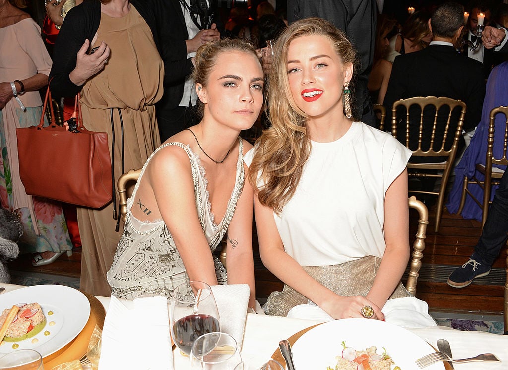 Cara Delevingne (L) and Amber Heard attend the de Grisogono 'Fatale In Cannes' party 