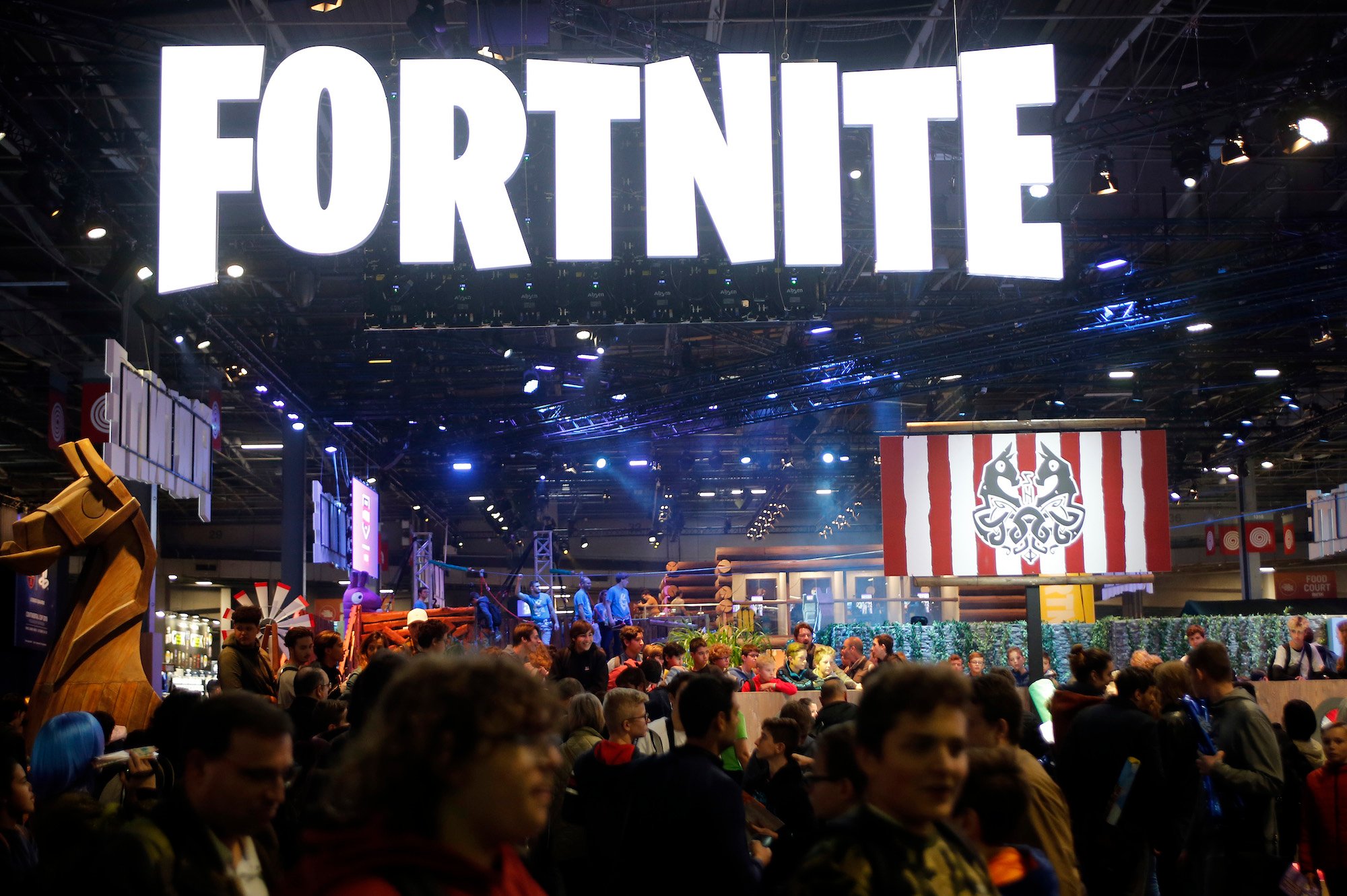 Fortnite lighted logo above a crowd of people in a convention center