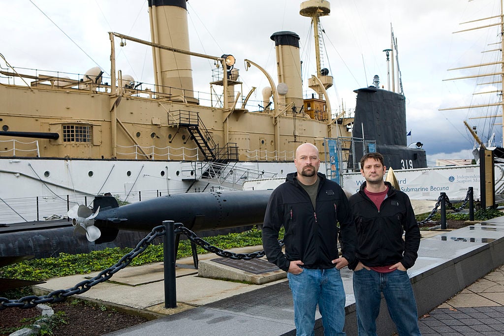 Jason Hawes and Grant Wilson standing in front of a ship