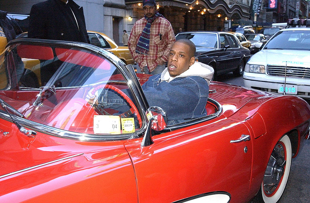 Jay-Z sitting in a red convertible