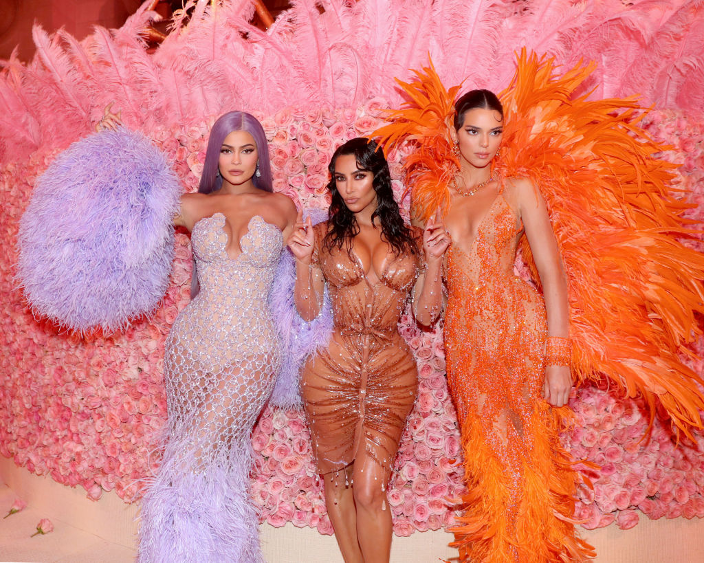 Kylie Jenner, Kim Kardashian West and Kendall Jenner in purple, nude, and orange dresses