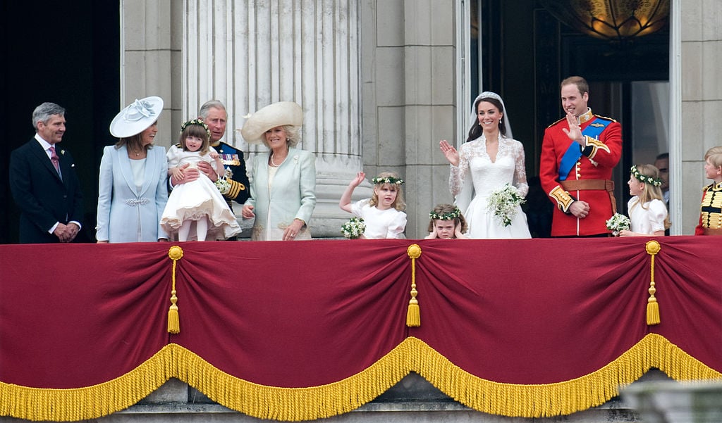 Kate Middleton and Prince William stand on the balcony of Buckingham Palace at their royal wedding with royal family and Middleton family