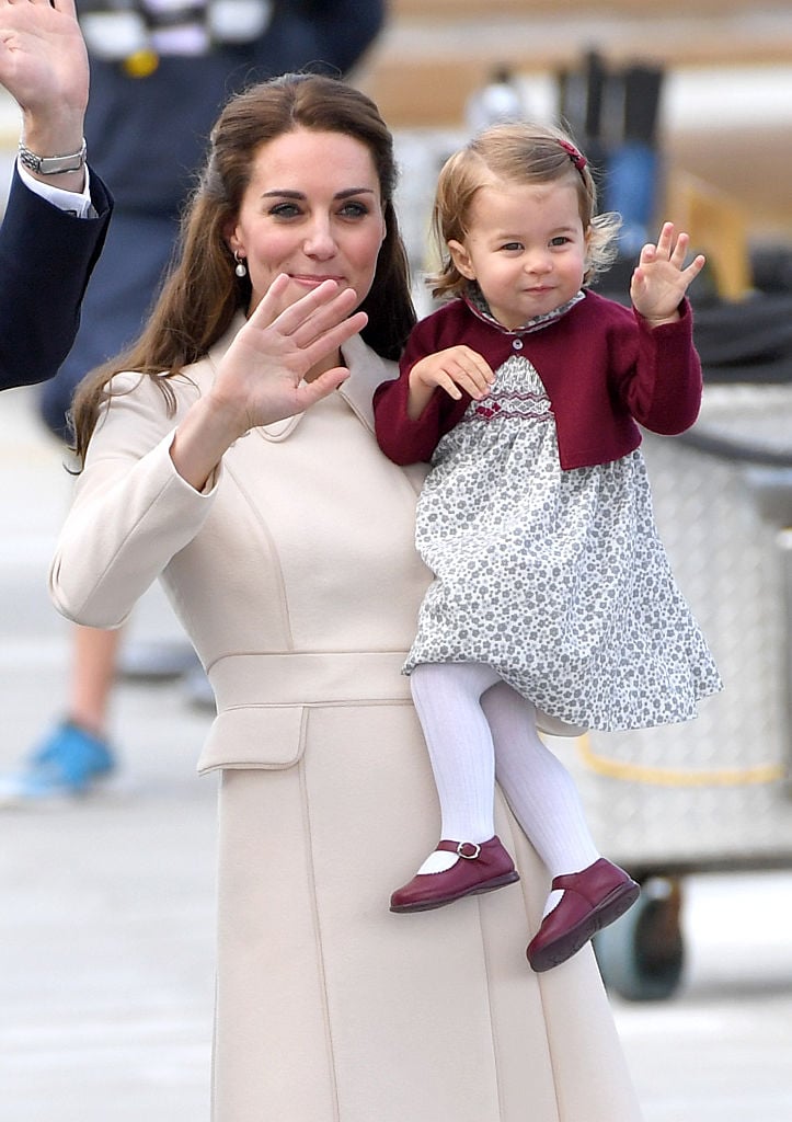 Kate Middleton and Princess Charlotte wave to crowds during a 2016 royal tour of Canada