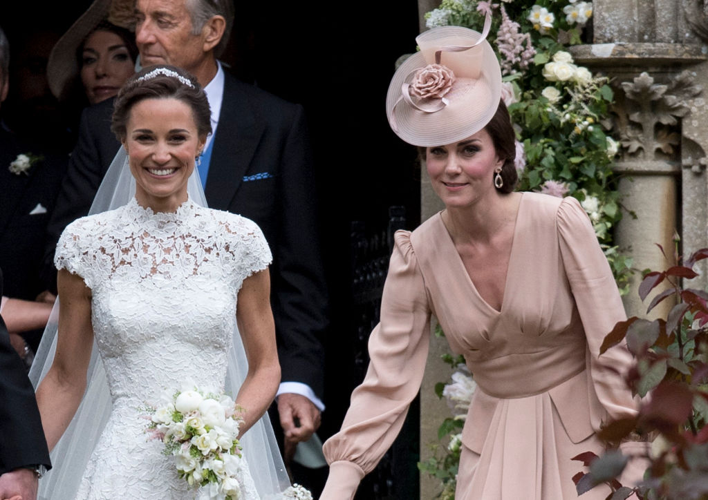 Kate Middleton stands with Pippa Middleton at her wedding 