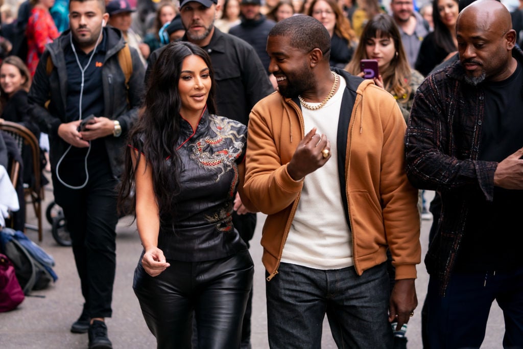 Kim Kardashian West and Kanye West walking down the street