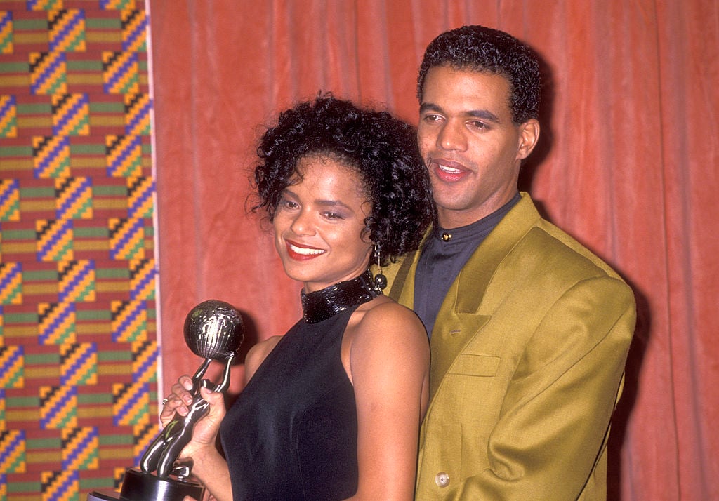 Kristoff St. John embracing Victoria Rowell, both smiling