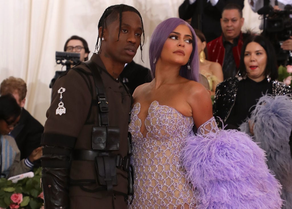Travis Scott and Kylie Jenner looking away from the camera