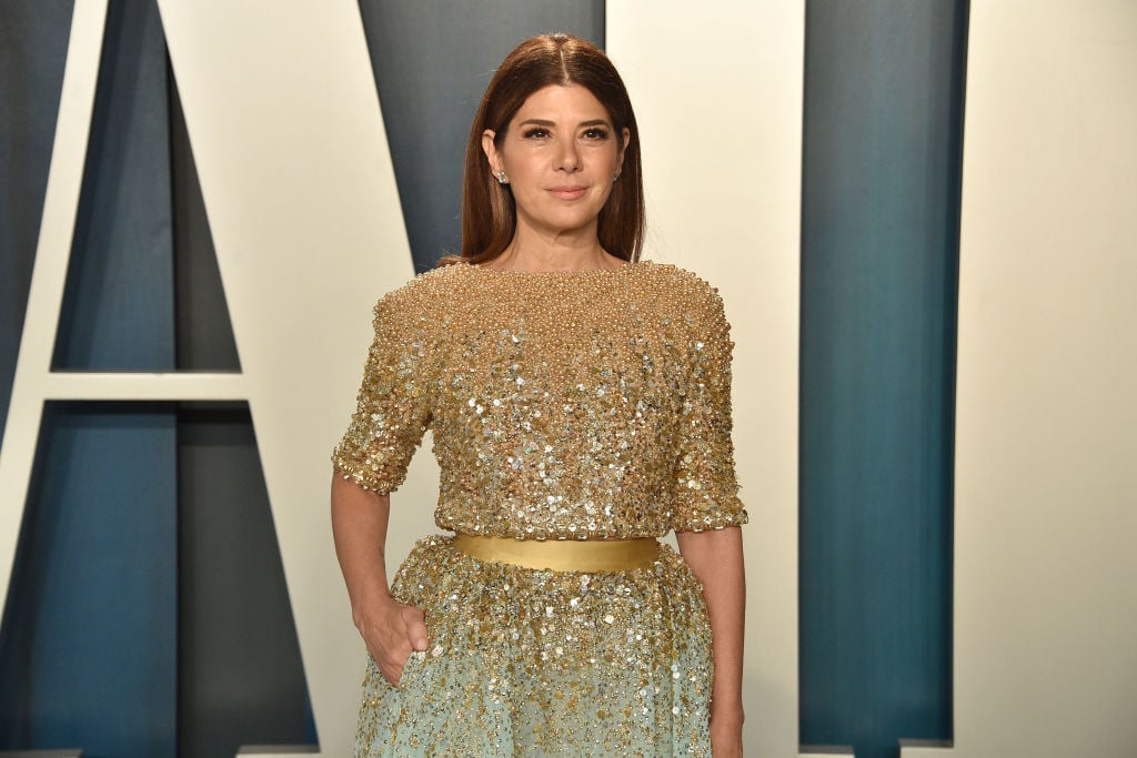 Marisa Tomei smiling in a gold and blue dress
